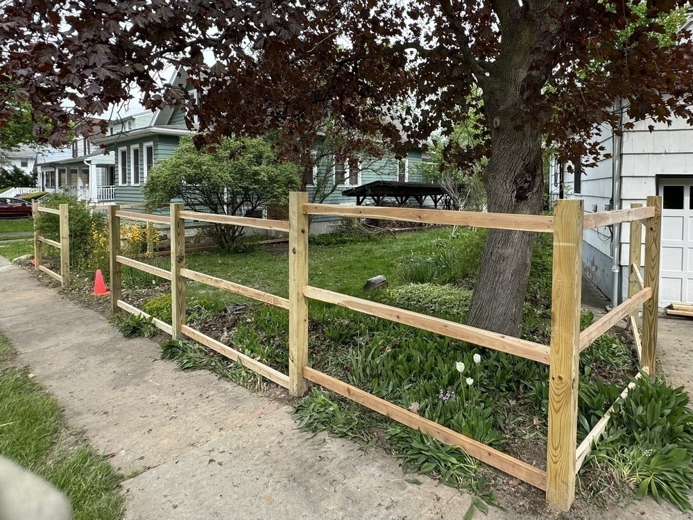 A framed out wooden fence surrounding a yard.