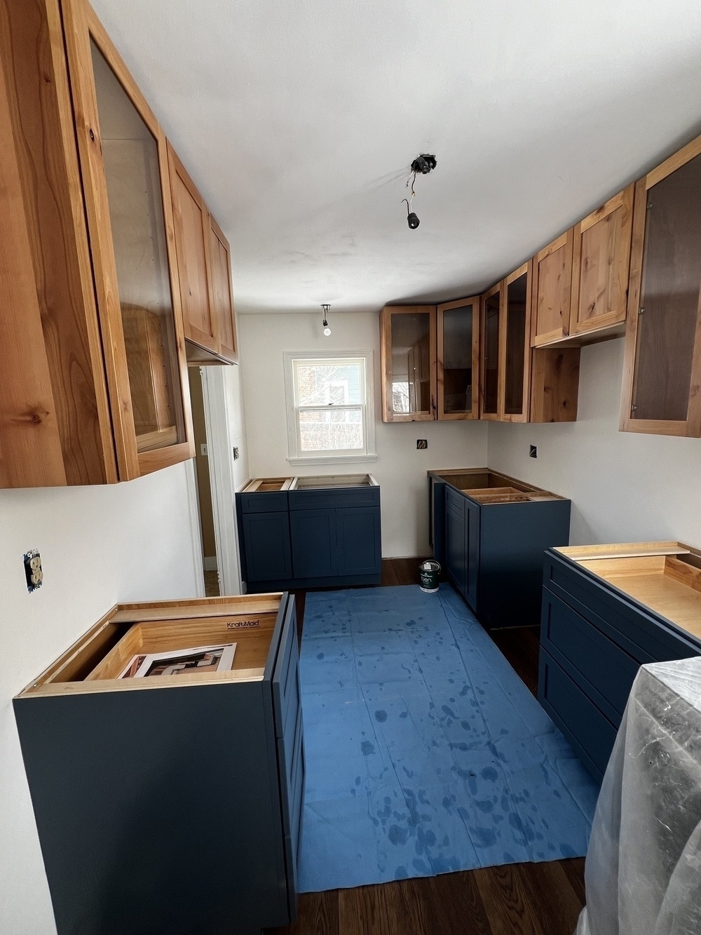 Freshly installed kitchen cabinets, with no countertops or appliances yet.