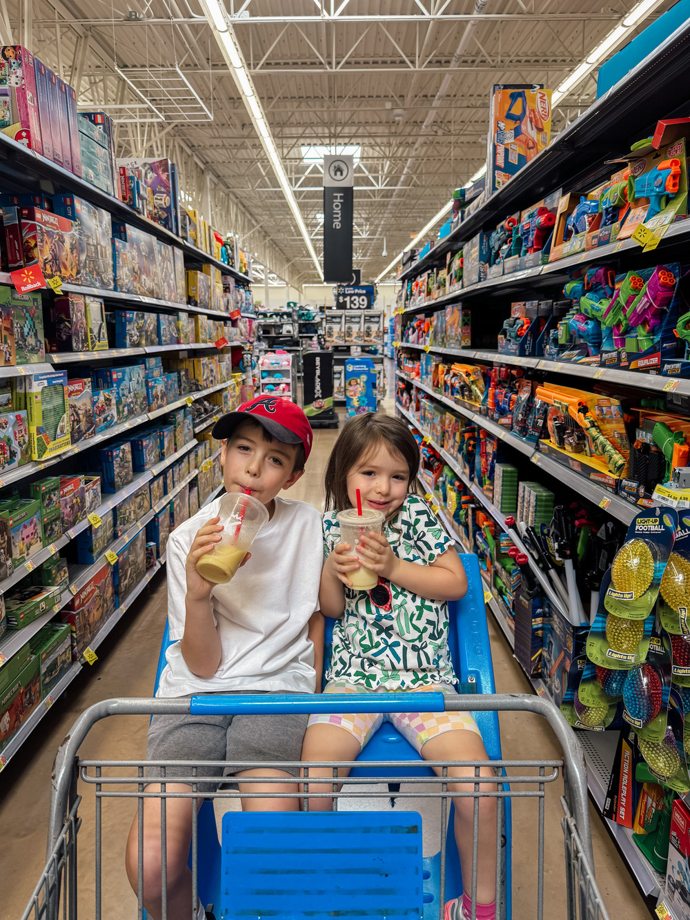 Two kids in a big buggy on the LEGO aisle in Walmart