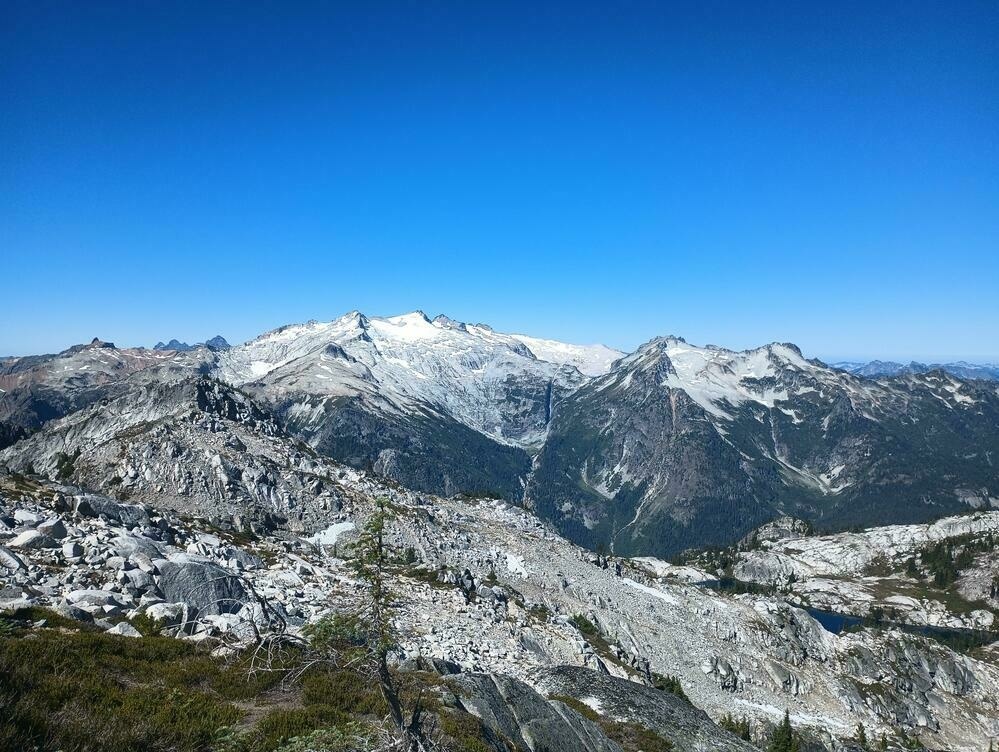 Looking across the Tucqualah valley at Mount Daniel. Rocky granite ridge lines are everywhere. The roar of glacier fed waterfalls can be heard from even here.