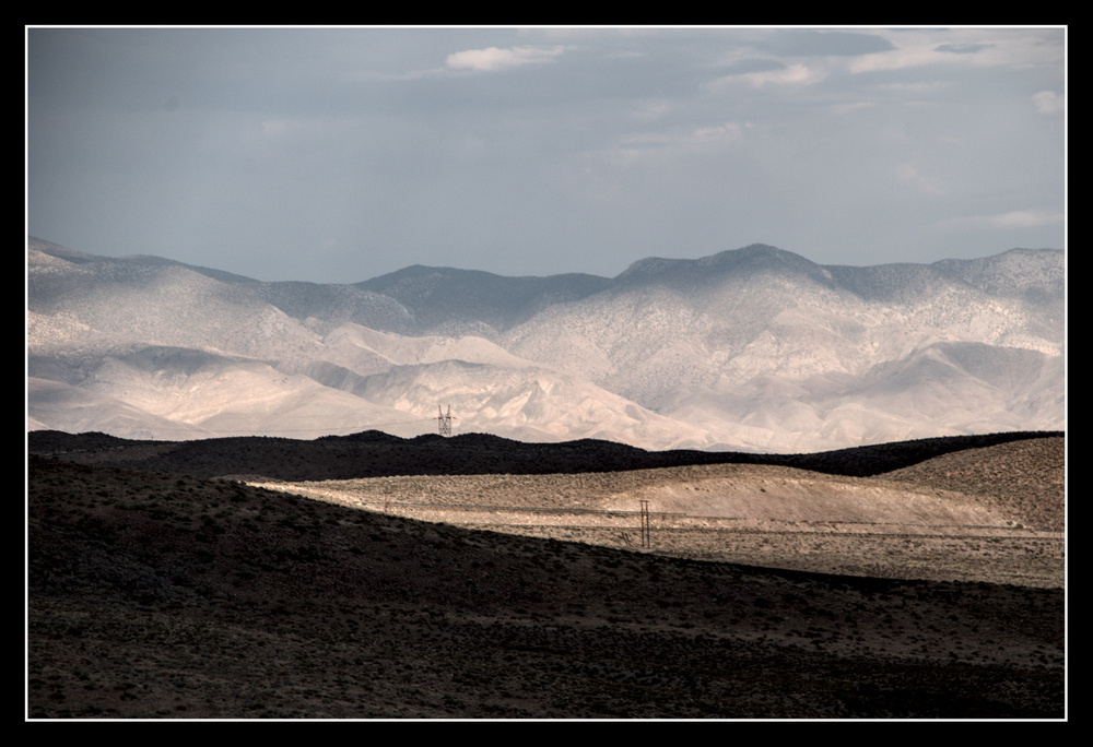 Alternating sunlight and clouds make sharp contrasts on a high desert landscape.