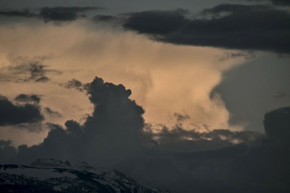 Two clouds that look like heads face each other.