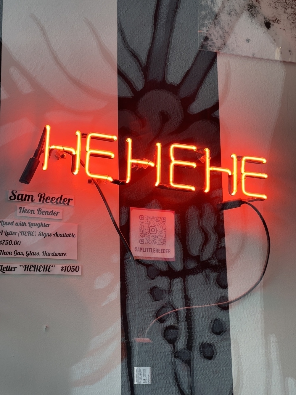 Neon sign saying HEHEHE.