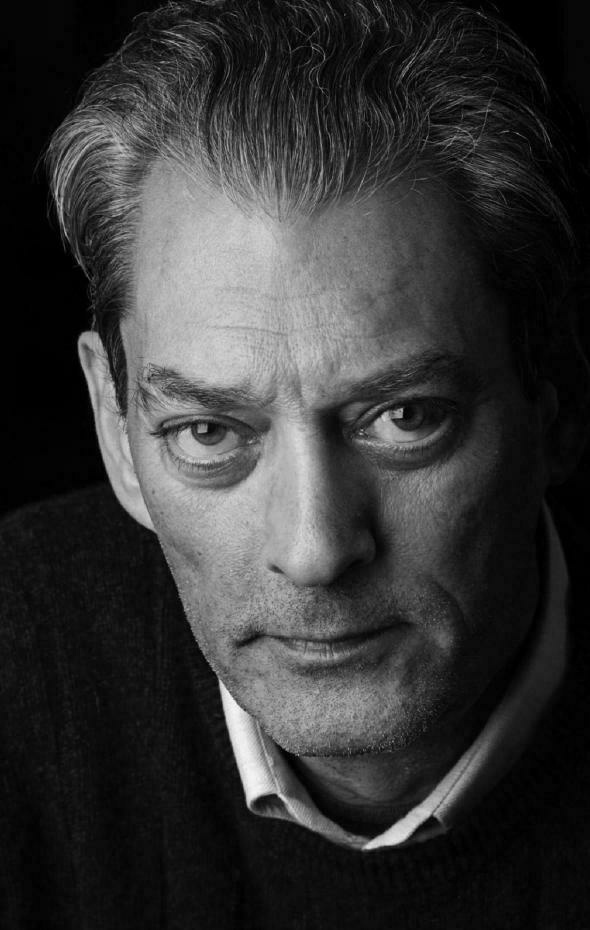 Auto-generated description: A black-and-white portrait features Paul Auster with intense gaze and a distinguished, slightly furrowed expression, having prominent facial lines and slicked-back hair, dressed in what appears to be a sweater with a collared shirt underneath.