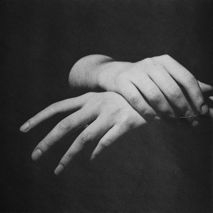 Rendez Vous EP cover. Monochrome picture of two hands, right one places above the wrist of the left one.