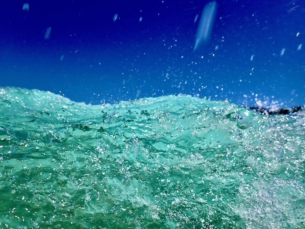 Water splashing from behind a breaking wave