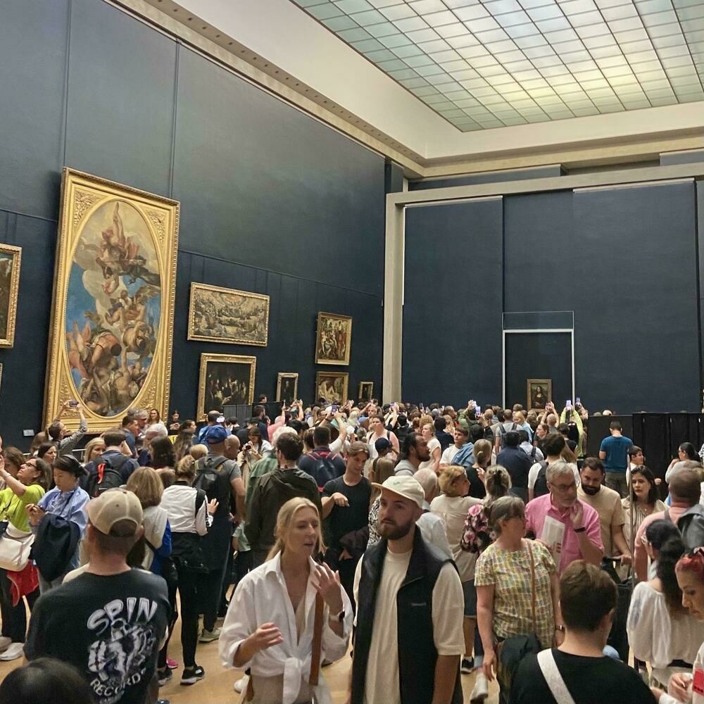 A large crowd in front of the Mona Lisa at the Louvre museum in Paris