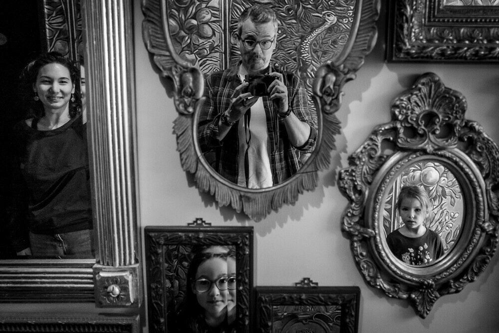 Monochrome image of my family; each family member is seen reflected in a different mirror