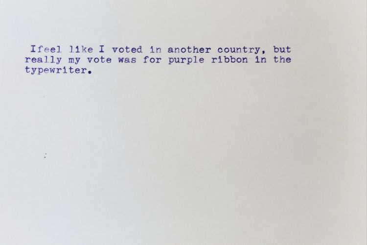 White index card typed in purple ink with this message: I feel like I voted in another country, but really my vote was for purple ribbon in the typewriter.