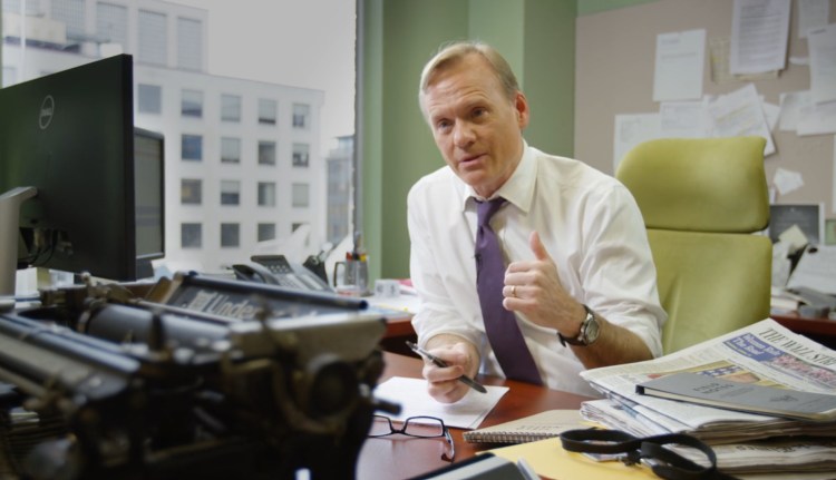 Reporter a boyish looking John Dickerson wearing a crisp white shirt (sleeves rolled up and a tie) sitting at his office desk surrounded by papers. In the foreground sits a black lacquered Underwood standard typewriter.