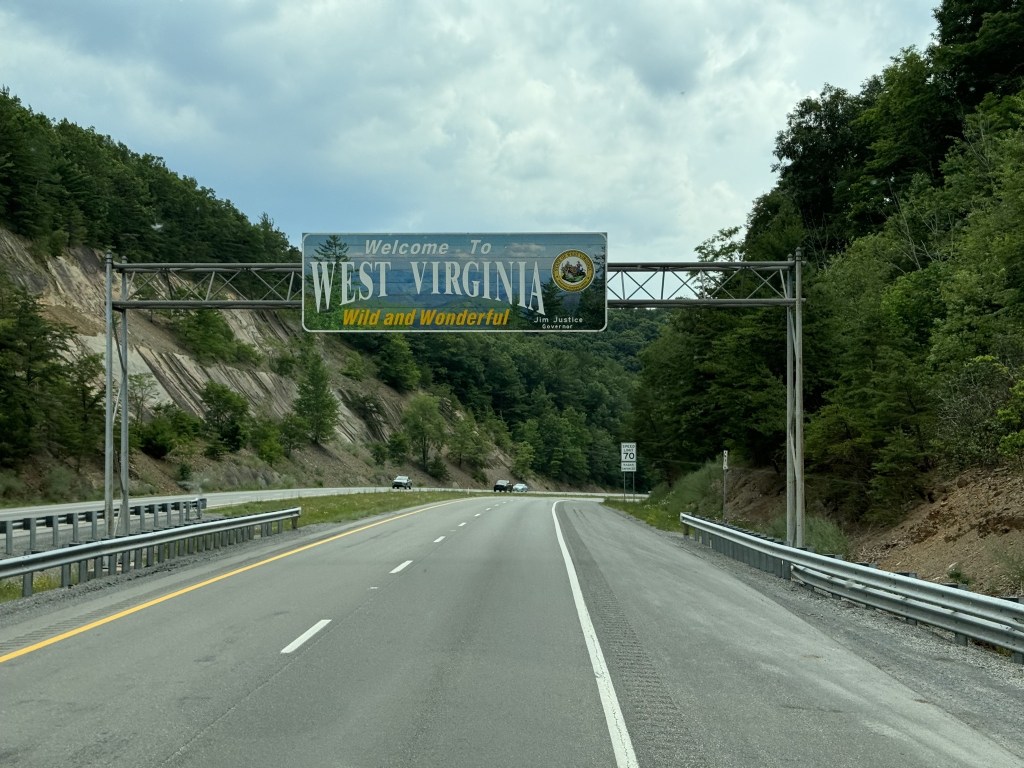 Welcome to West Virginia sign over freeway