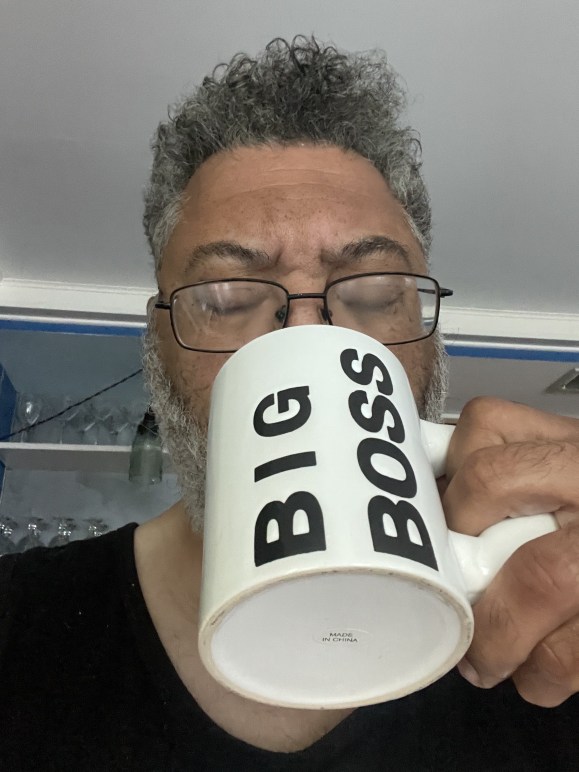 Me sipping from a coffee mug that says 