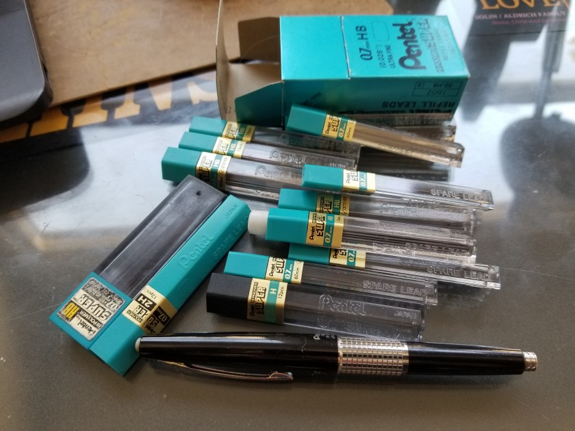 about a dozen tubes of refill lead and a lonely non-compatible black mechanical pencil