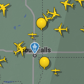 A map square with two balloon icons amongst many plane icons