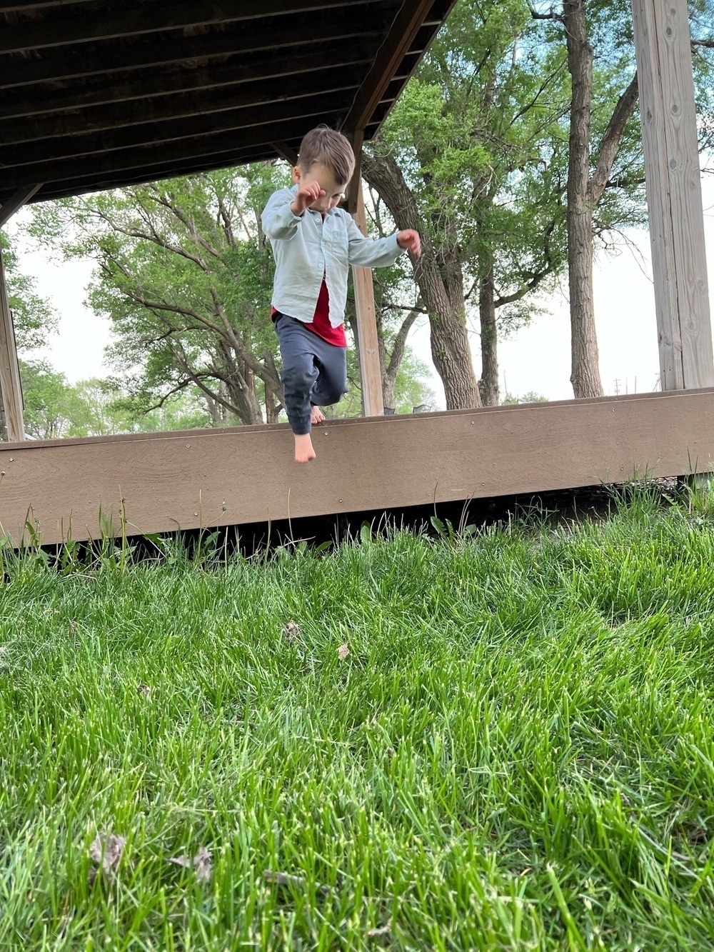 My boy, jumping from a backyard platform/stage and rolling onto the grass. 