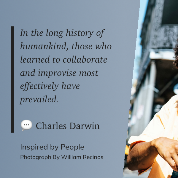 A quote by Charles Darwin about the success of collaboration and improvisation is displayed next to a blurred outdoor background and a person adjusting a camera.