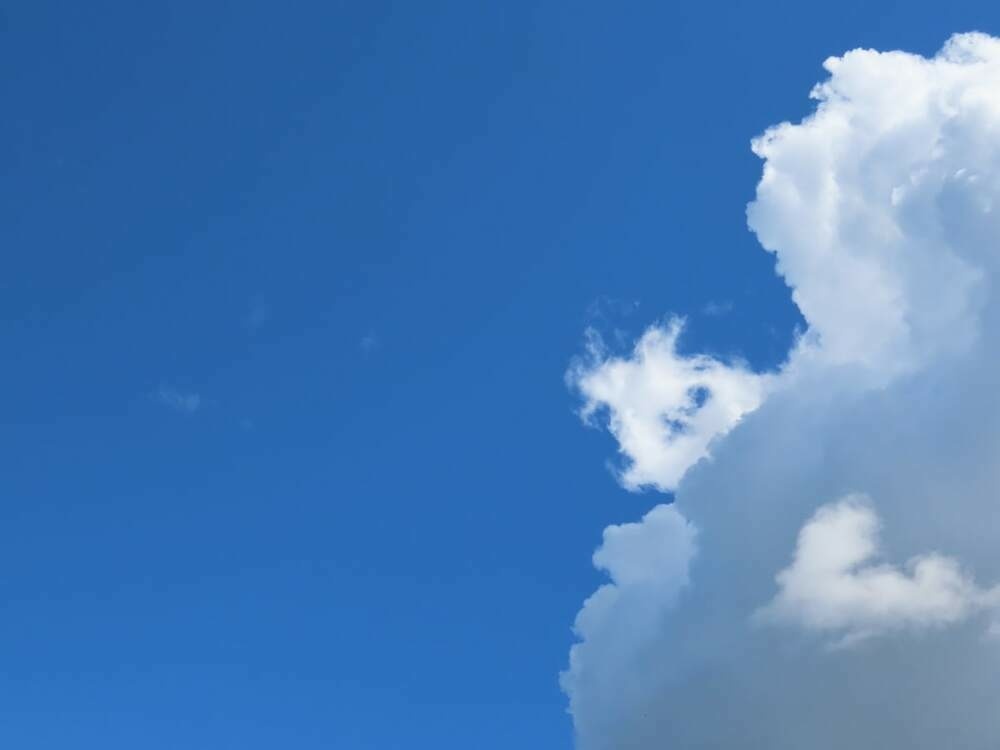 Large white cloud against a clear blue sky.