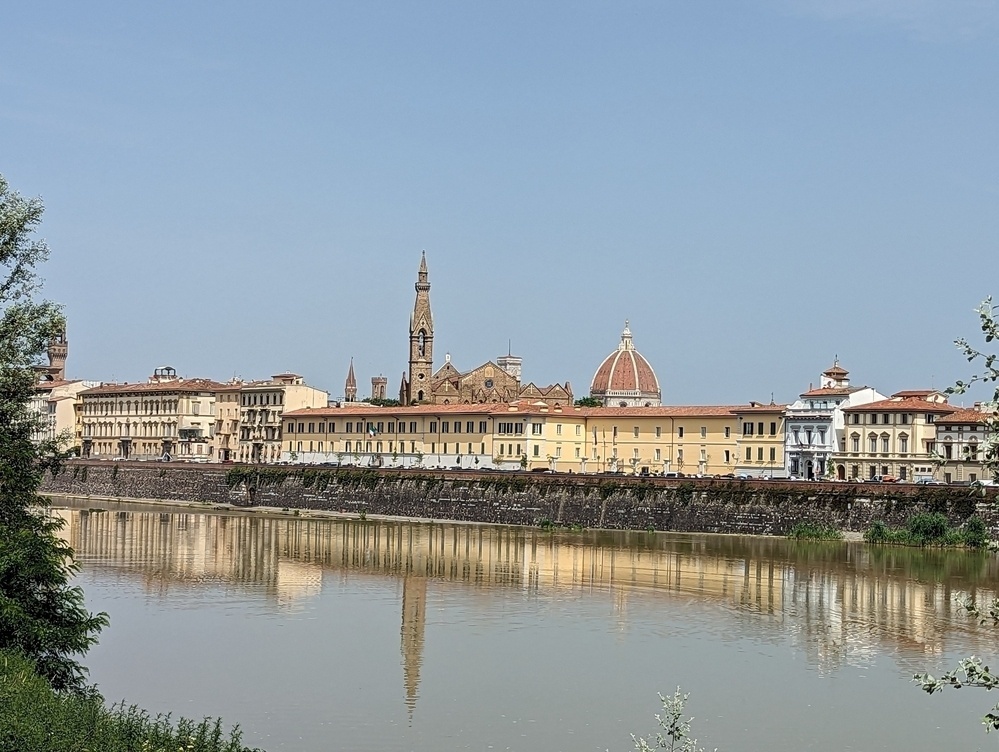 Florence skyline, with the dome of the cathedral, and buildings alongside the river. 