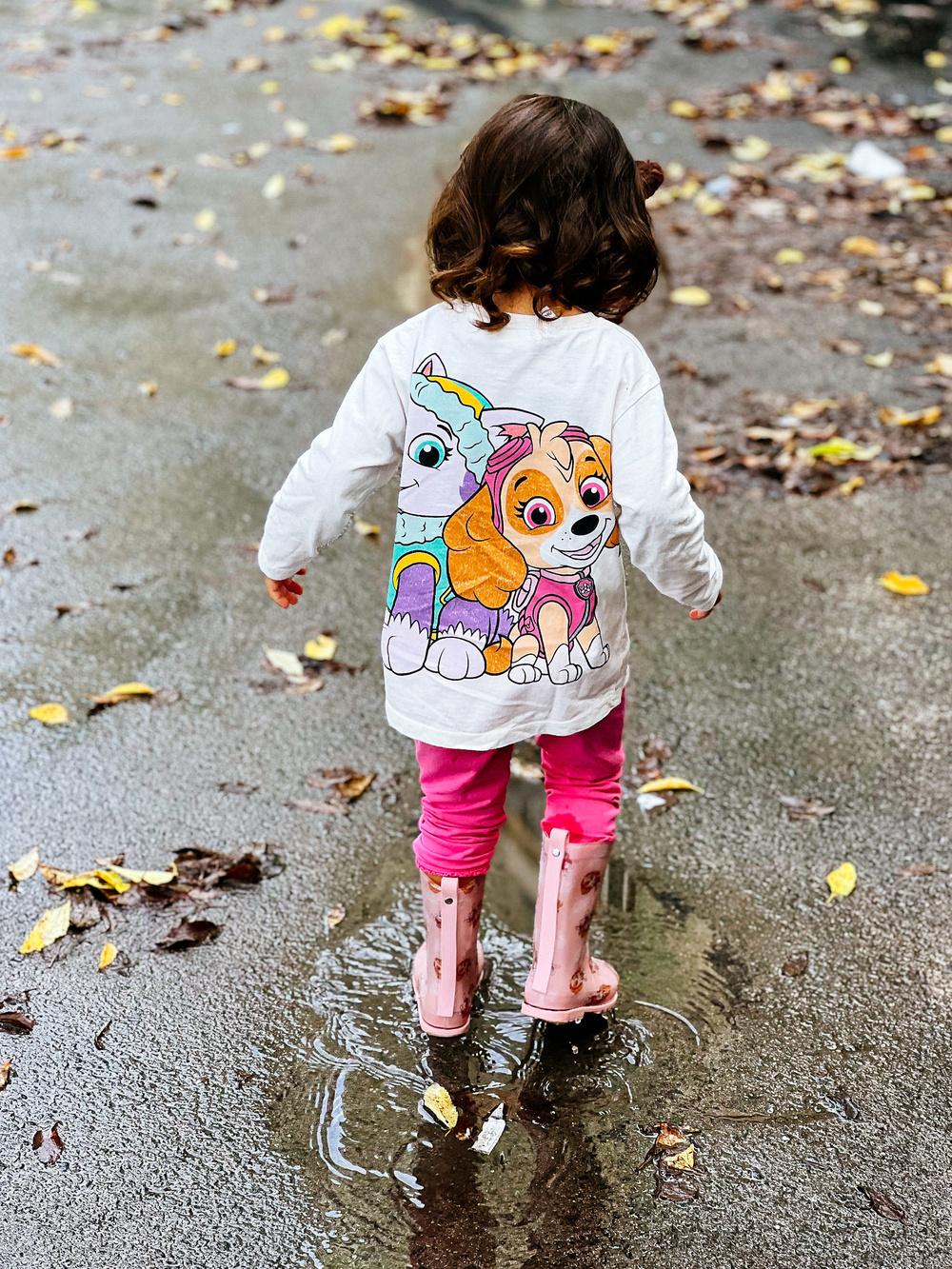 toddler jumping on puddles