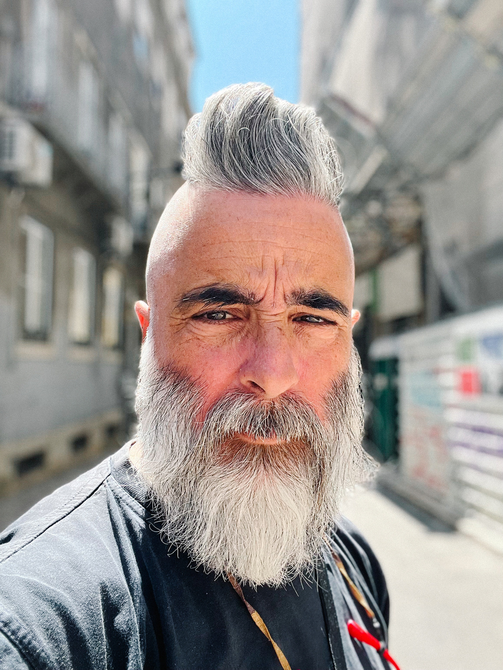 A bearded man (me), with a freshly cut Psycho haircut. 
