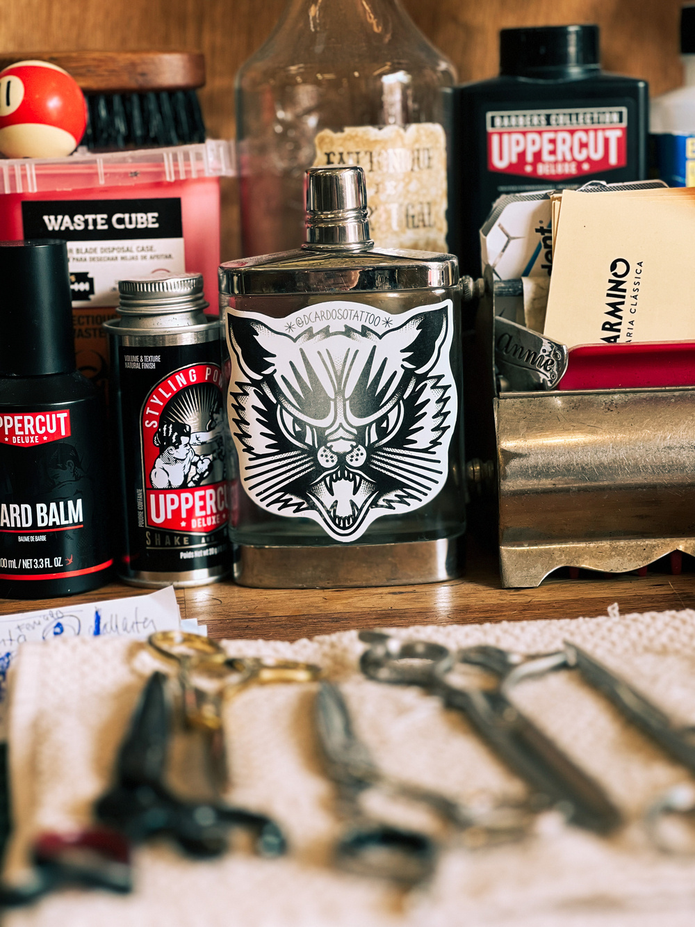 Detail of a barbershop, a cat sticker, and hair care products. 
