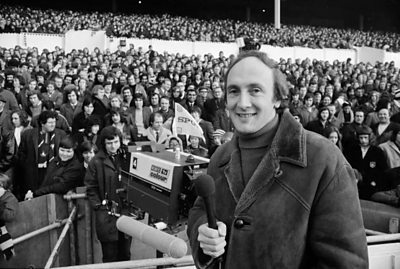 Barry Davies in front of football crowd