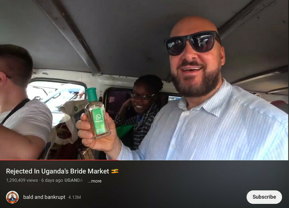 YouTube personality holding a bottle of WhatsApp perfume