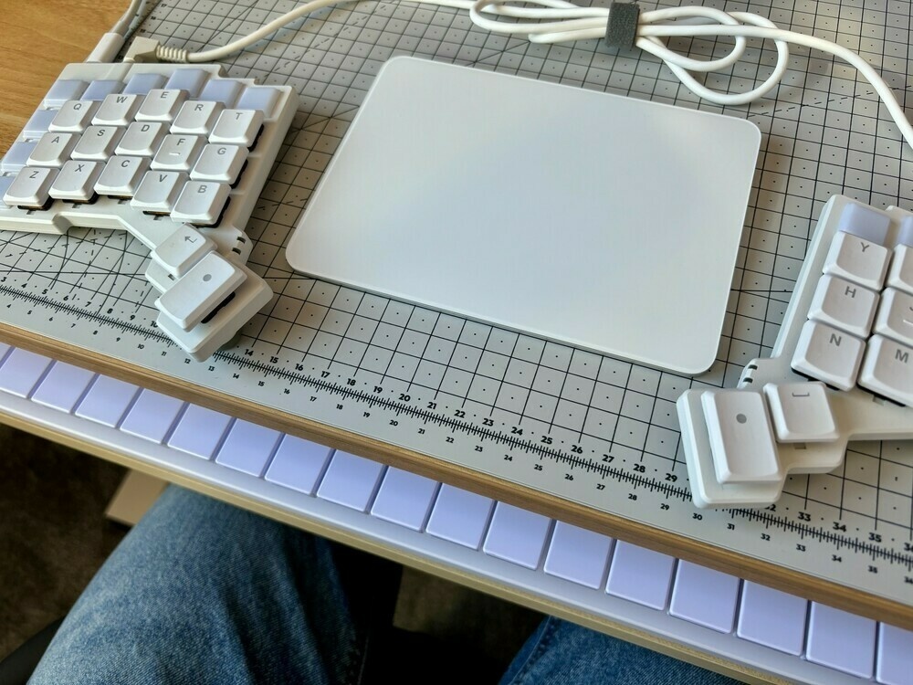 Cutting mat with split keyboard and trackpad on top