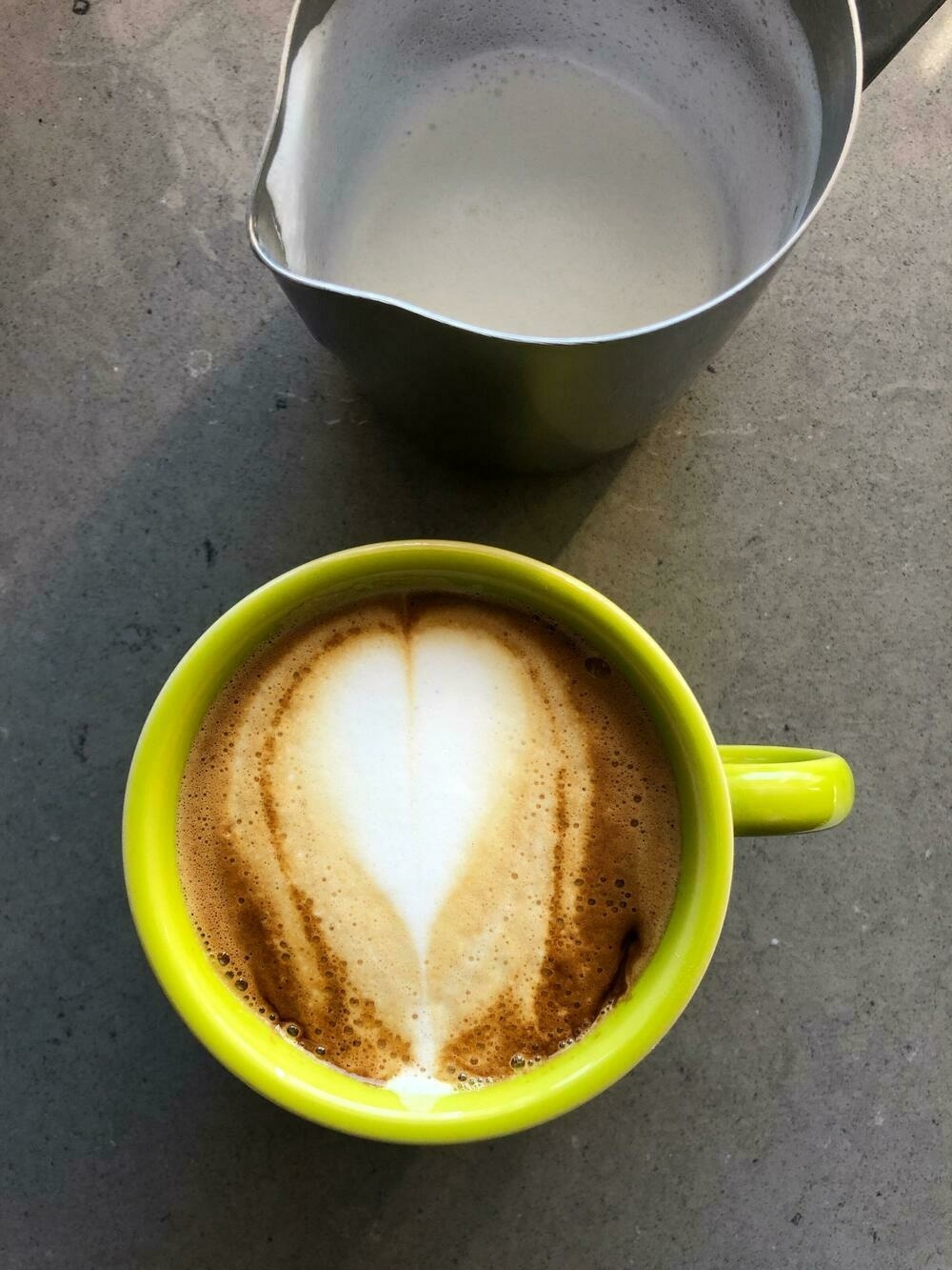 Photo of a cappuccino with a heart-shaped pour of milk.