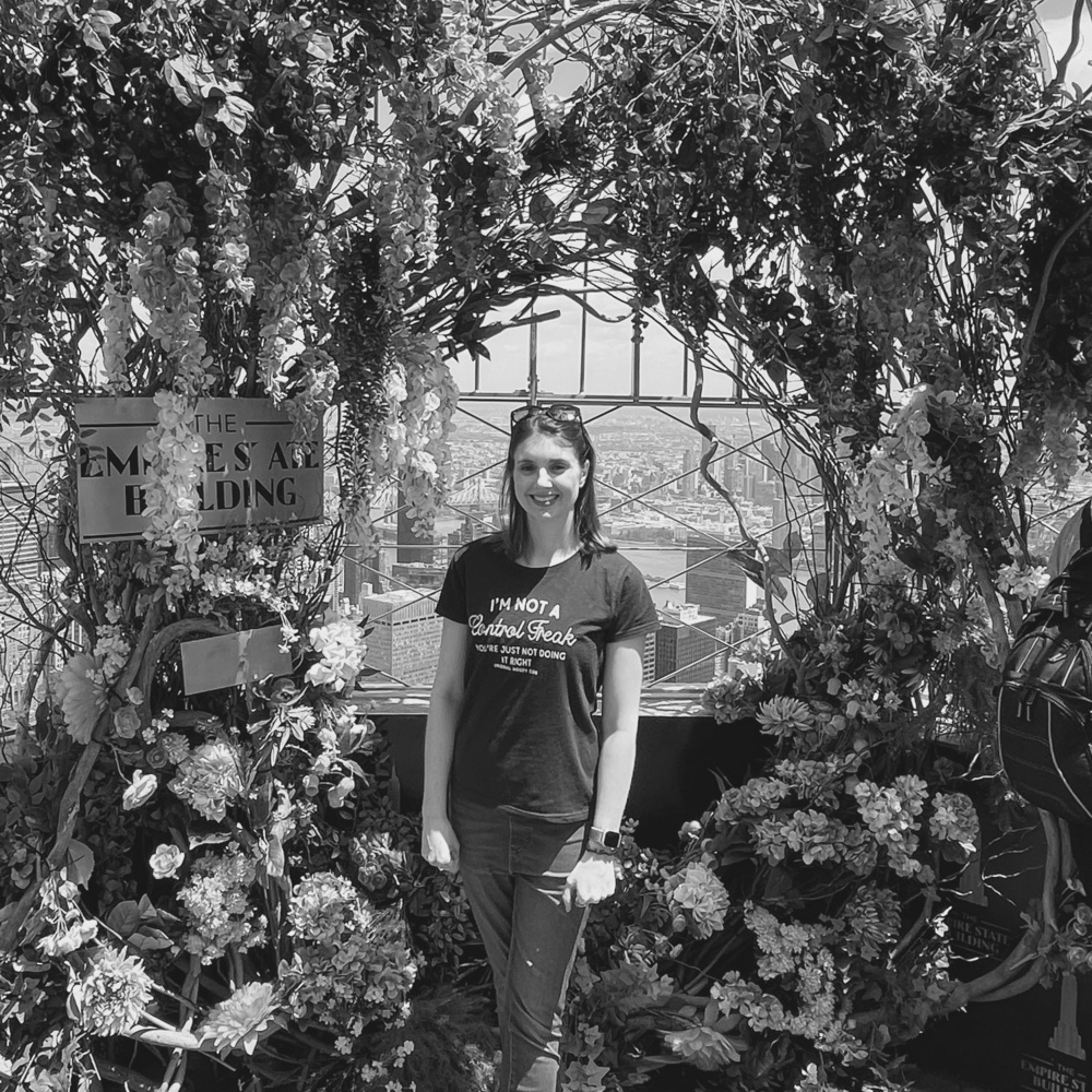 a black and white picture of me surrounded by flowers at the top of the Empire State Building