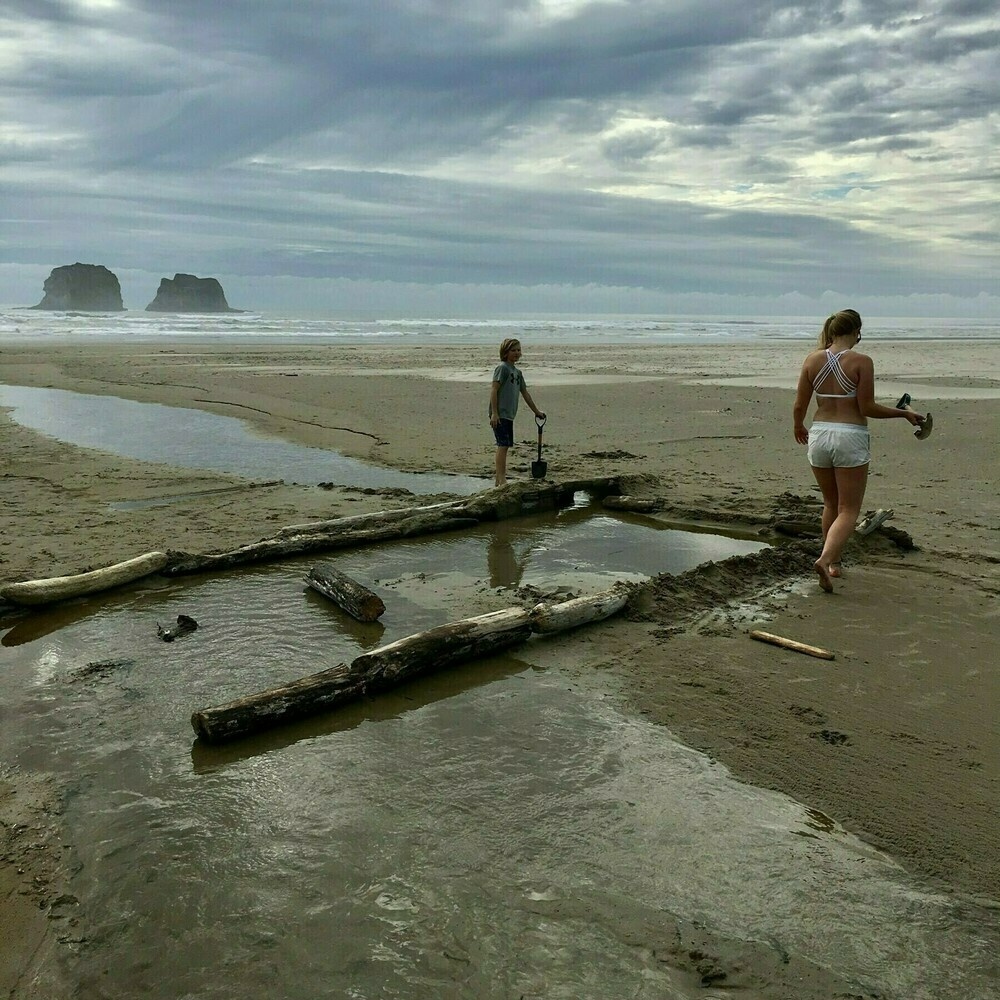 Twin rocks, Oregon coast, kids building a dam