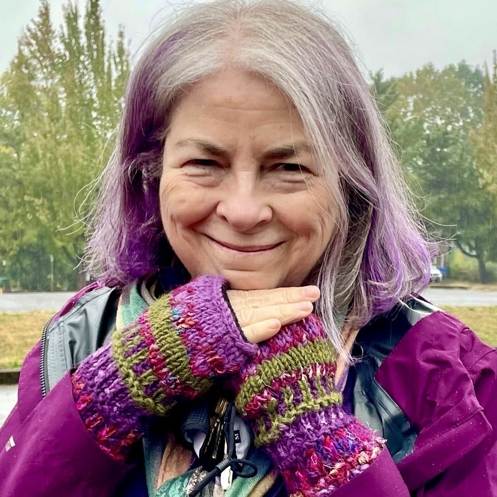 Me with purple highlights in my silver hair, plus purple rain jacket and gloves