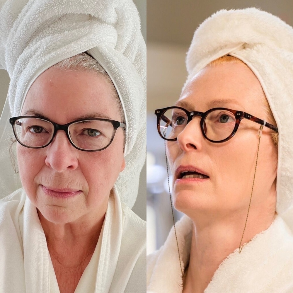Me dressed as Tilda Swinton aka Professor Alithea Binnie, in white bathrobe with hair wrapped in white towel, wearing glasses