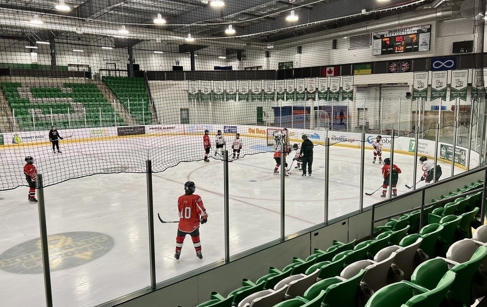 Photo of kids at a hockey practice in a hockey rink. &10;&10;