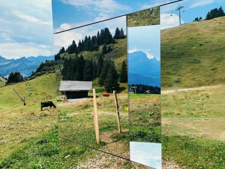 Mountains landscape saw through an art installation made of mirror