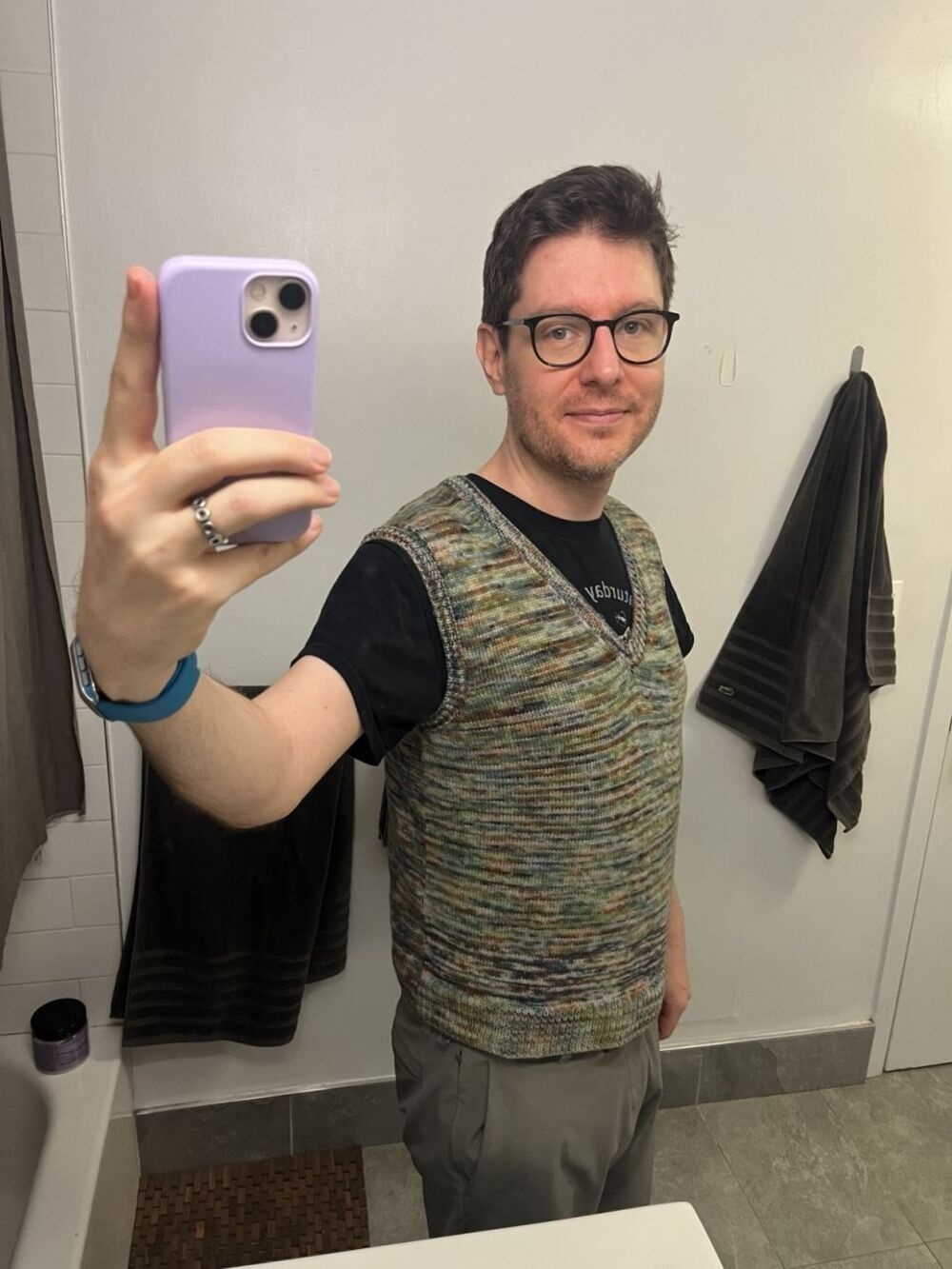 Me taking a selfy in a green, white, and brown variegated sweater vest.
