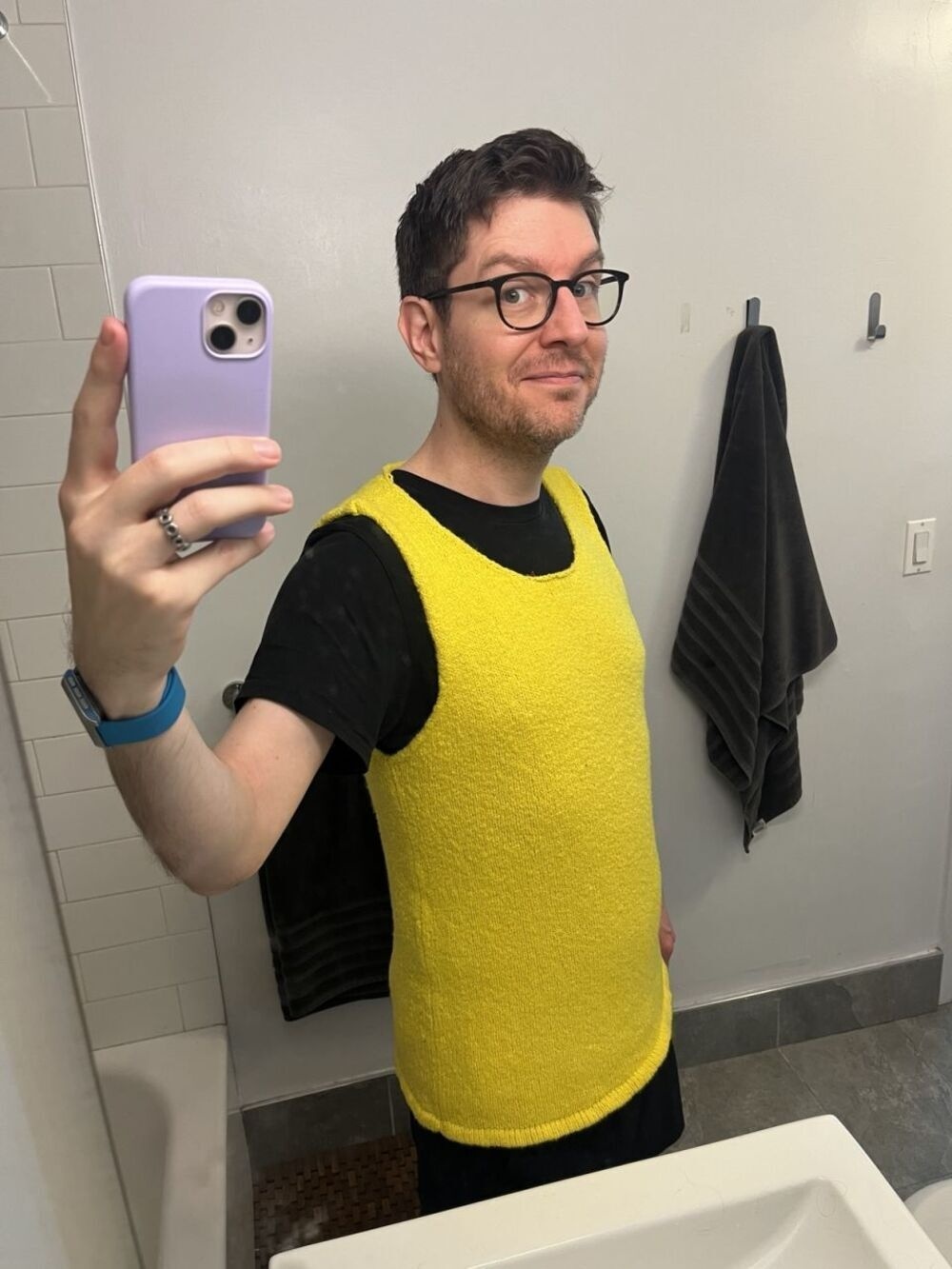 Me taking a selfie in a bright yellow sleeveless knit top.
