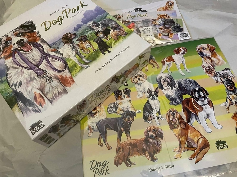 Boardgame Dog Park with multiple breeds of dogs posing on cover and extra components depicting multiple breeds of show dogs. A Day iin the Life photo challenge