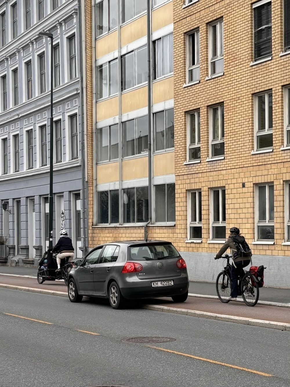 car parked in bikelane. Bikes passing, almost crashing