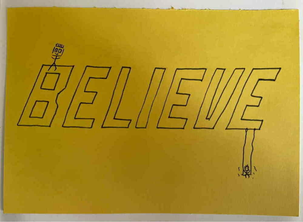 Believe text on yellow background. With two stick figures on it.
