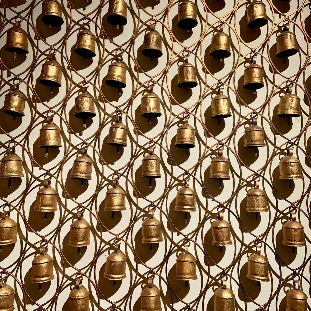 many bells hanging from a frame