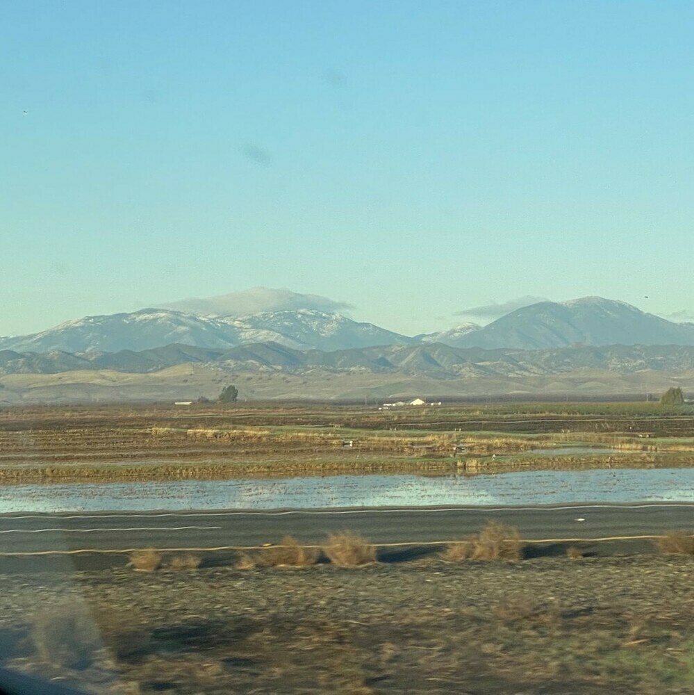 snowy mountain tops along a highway