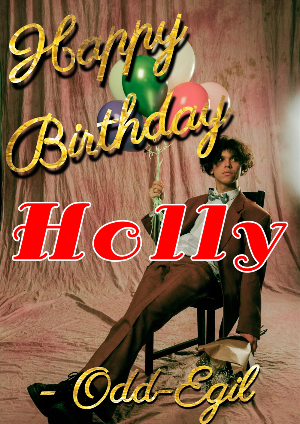 A person dressed in a suit, sitting on a chair, holding a bouquet of balloons. The background is draped with a pink cloth. Gold text at the top reads “Happy Birthday,” red text in the middle says “Holly,” and gold text at the bottom says “Odd-Egil”.