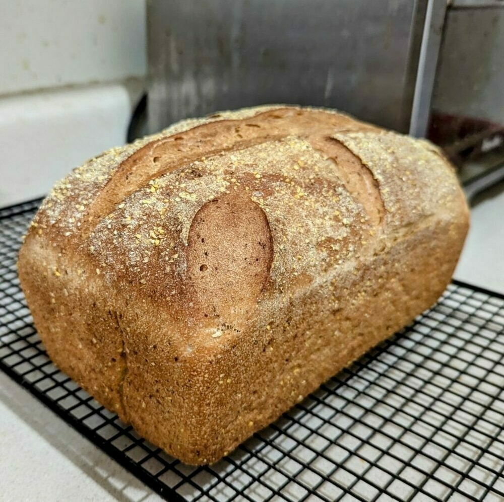 A loaf of bread on a cooling rack