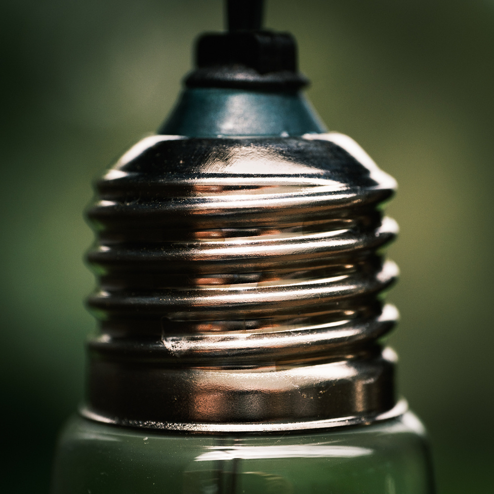 Close up photo of the threaded end of a small hanging lightbulb.