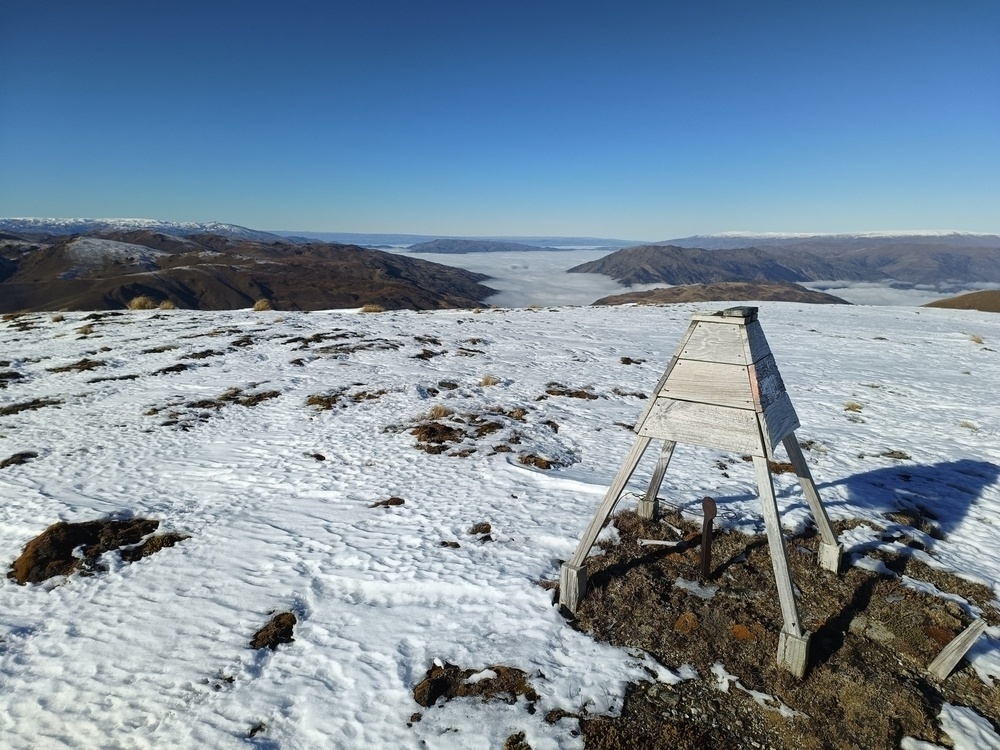 Trig station on hill above an inversion layer down the valley