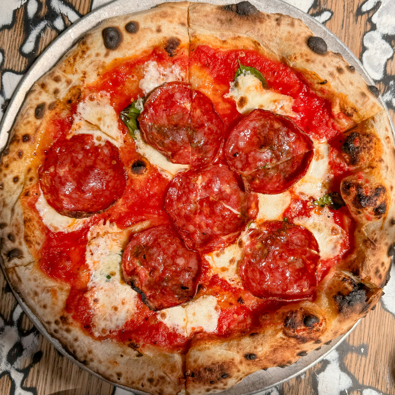 Bee Sting pizza with soppressata, mozzarella, and tomato sauce